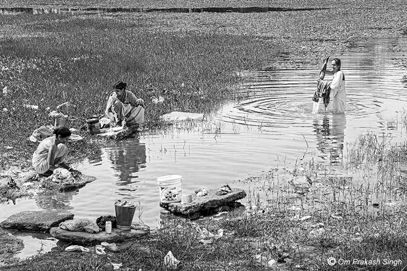 Washing the day’s clothes at a pond located on the village outskirts in Seraikela-Kharsawan district, Jharkhand, India
